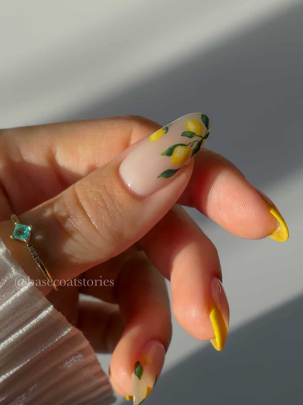 nude almond nails with yellow tips and lemon nail art