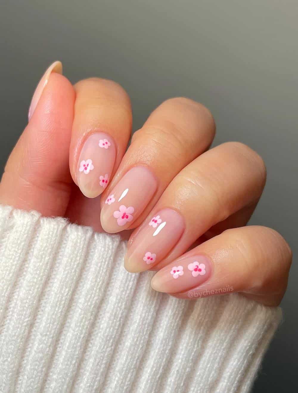 short nude almond nails with pink floral nail art