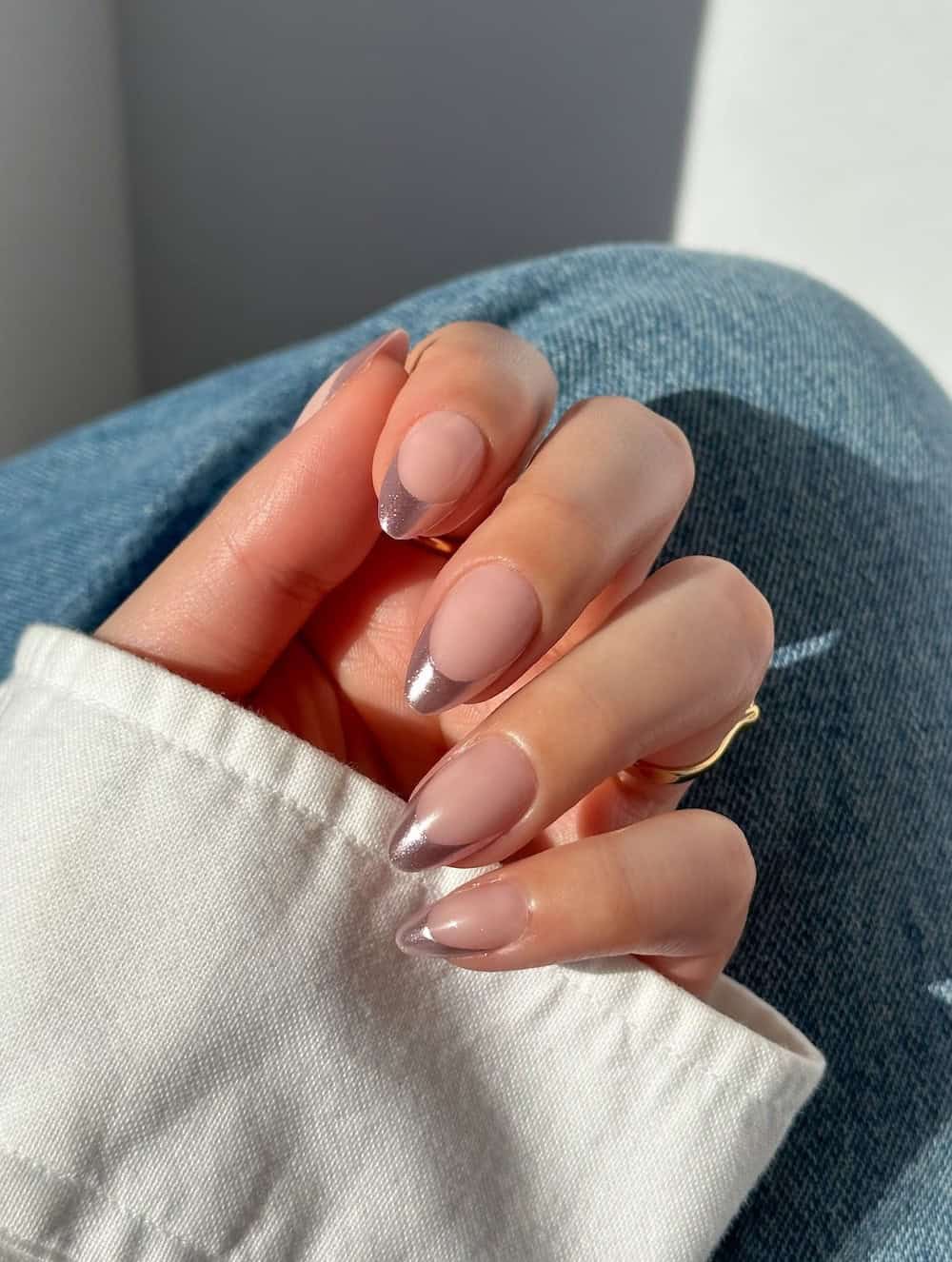 nude almond nails with metallic pink tips