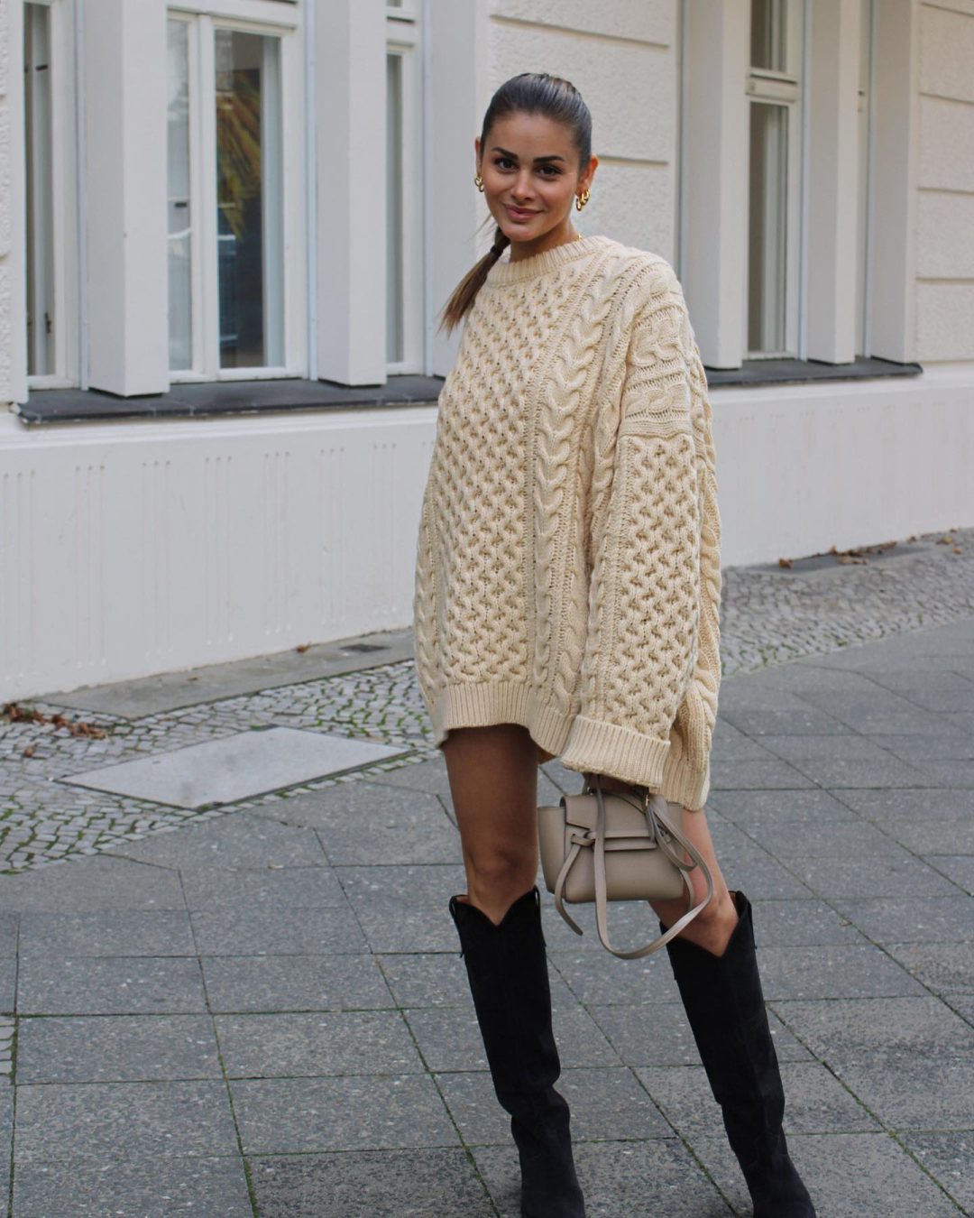 Cream sweater dress outfit with black knee-high boots