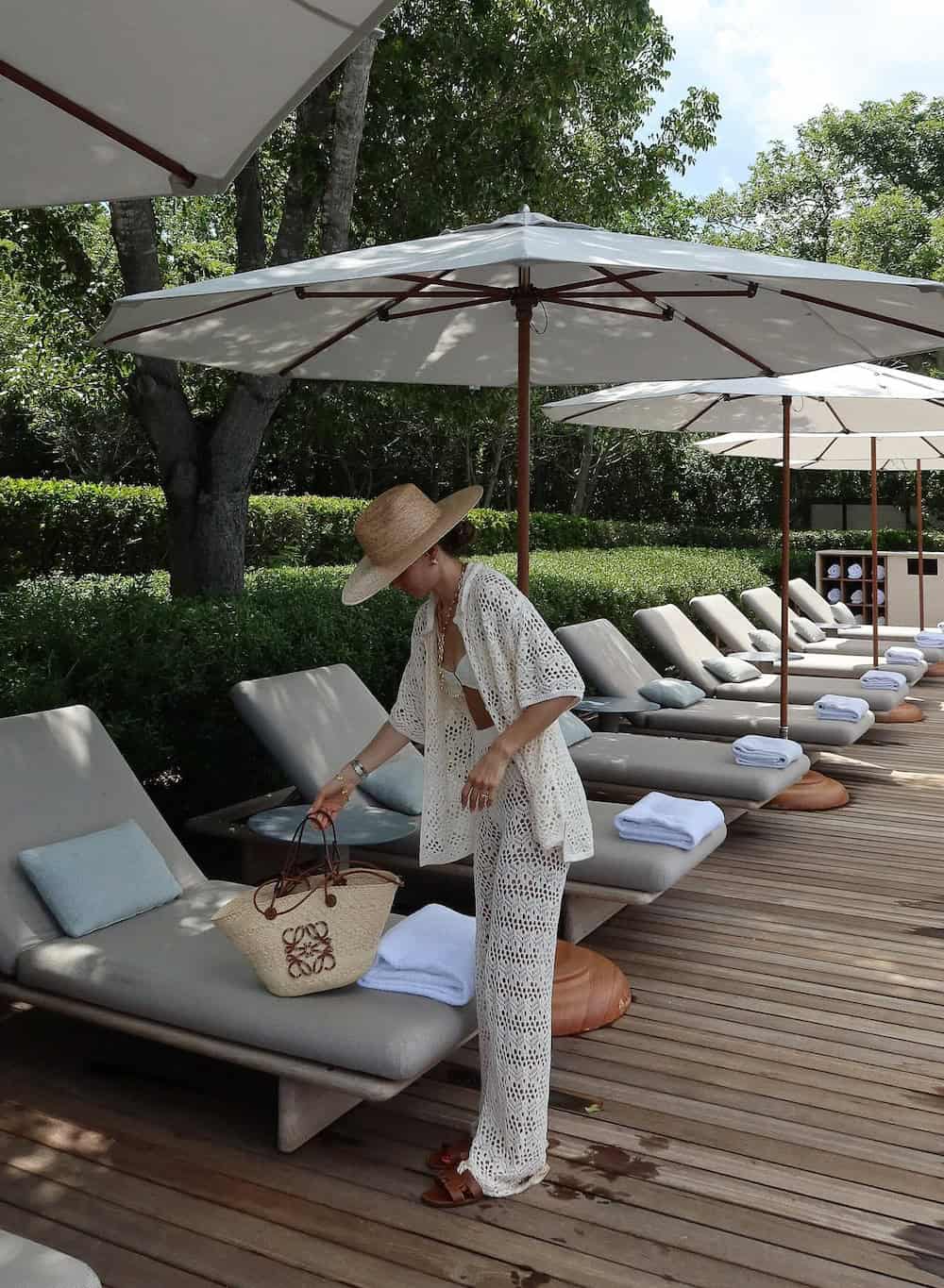 Woman wearing a white crocheted set at a resort.