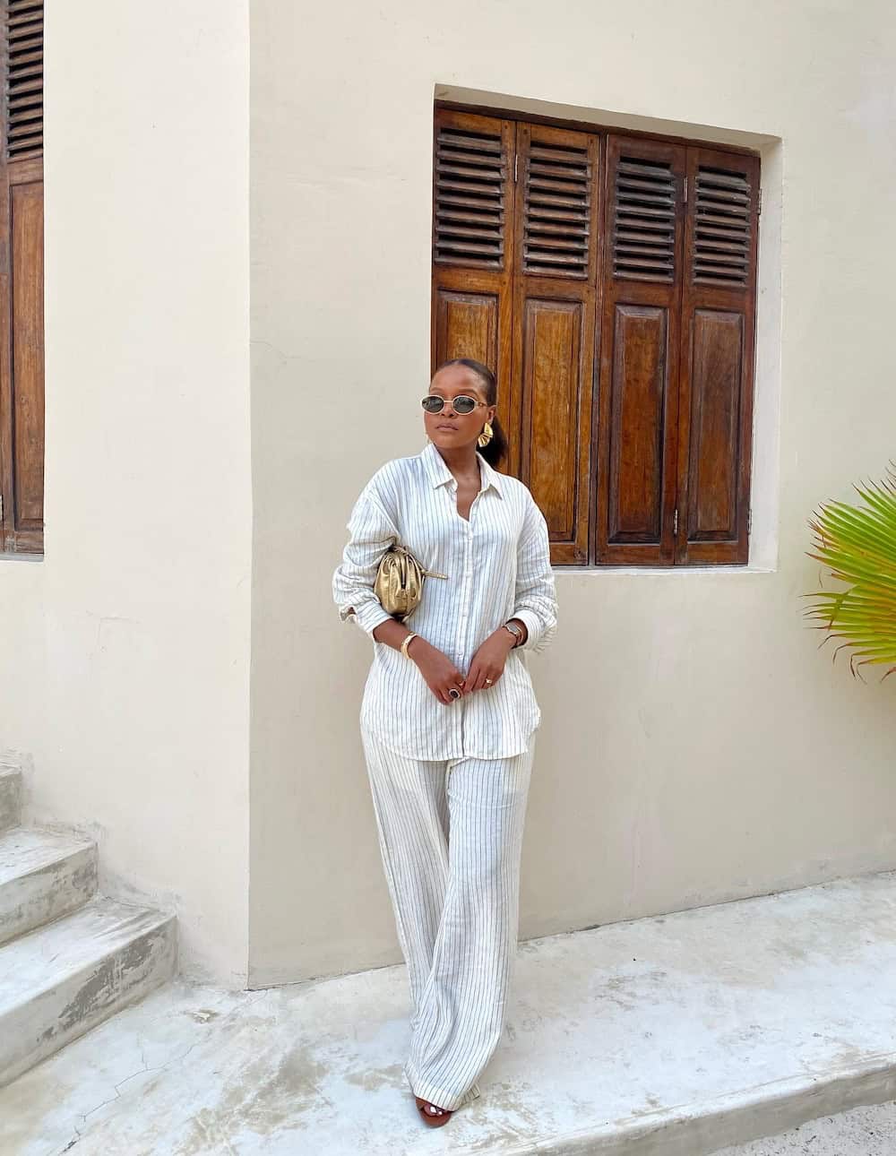 Woman wearing a white striped linen set.