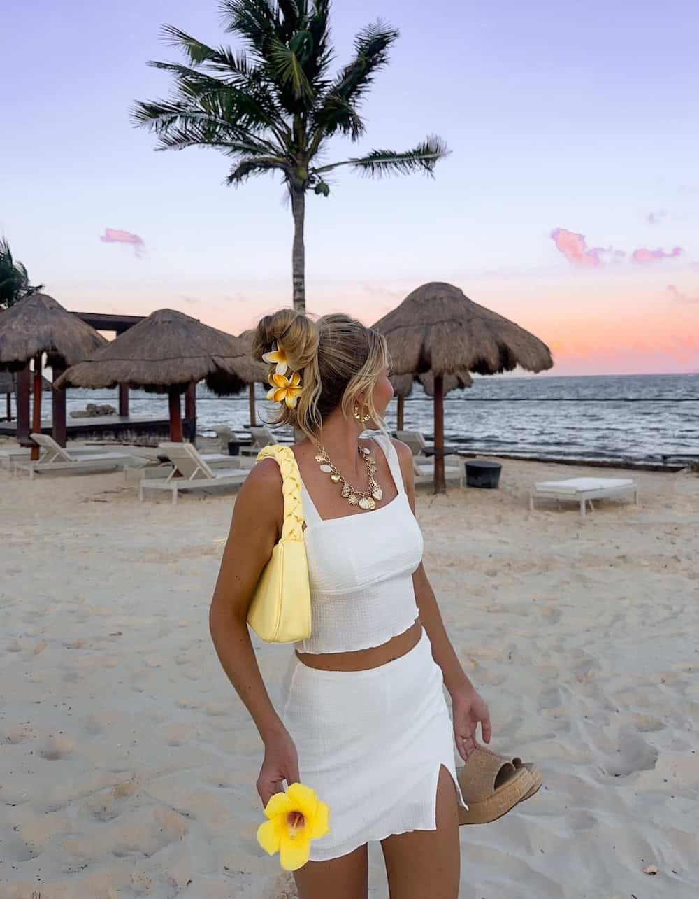 Woman wearing a white two-piece skirt set.