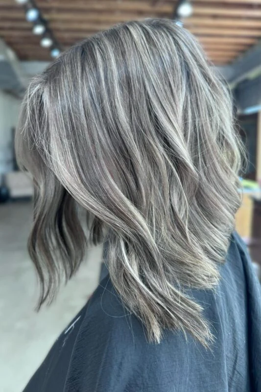 White blonde highlights elegantly covering gray in dark hair.