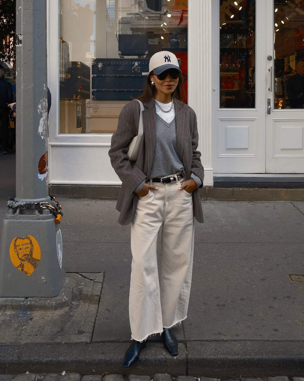 Woman wearing tan wide leg jeans and an oversized blazer.