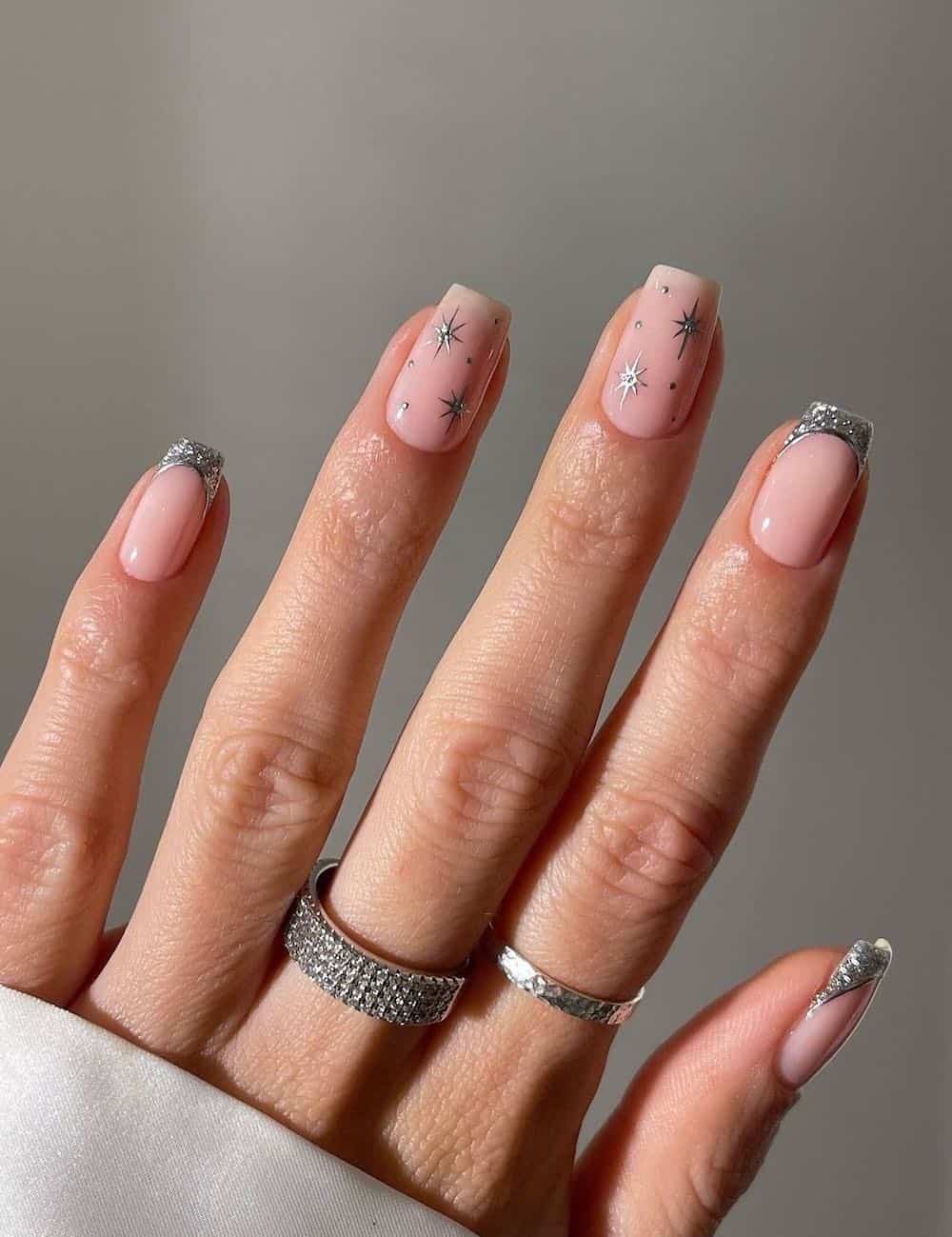 short nude nails with silver tips and sparkles