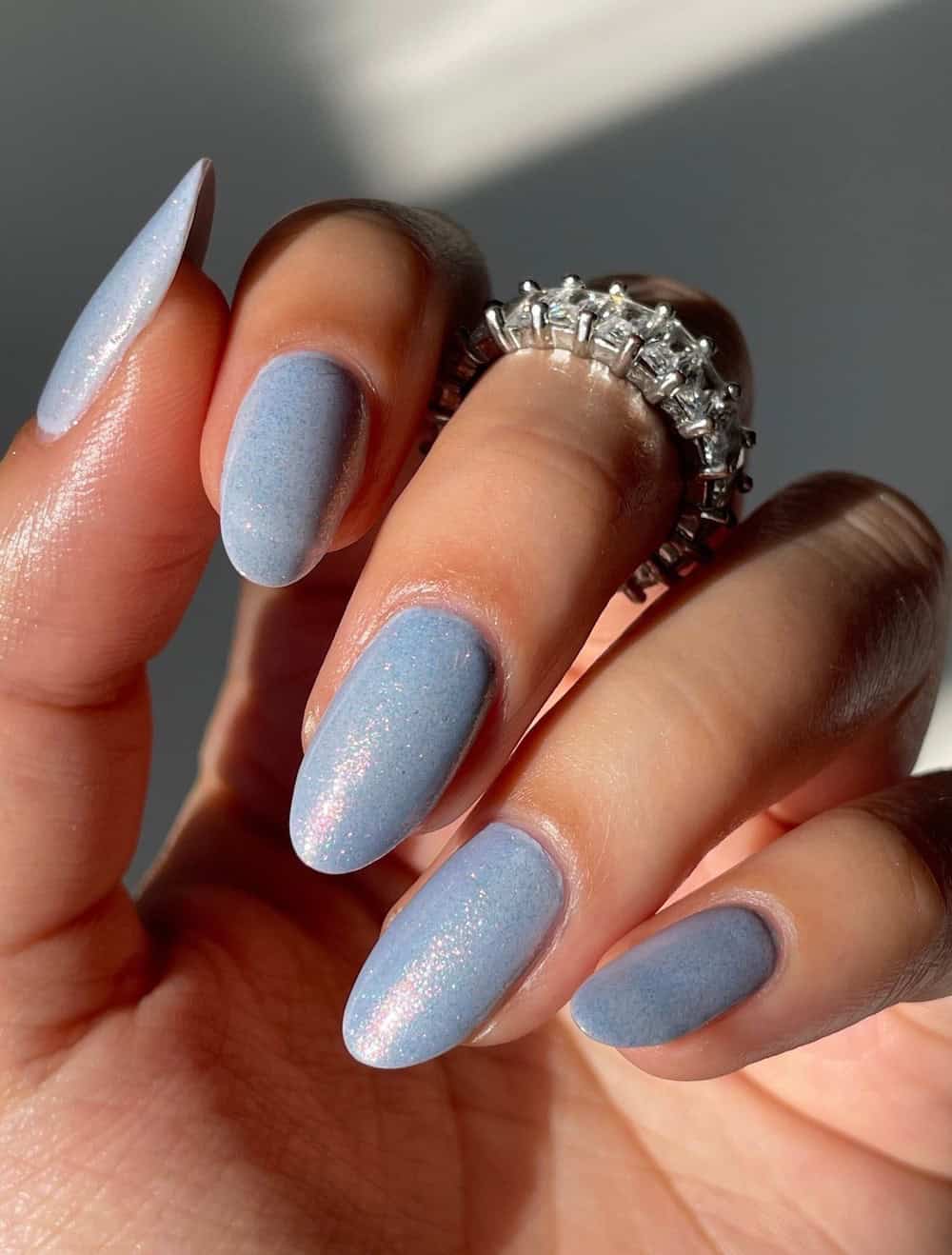 long shimmering blue almond nails