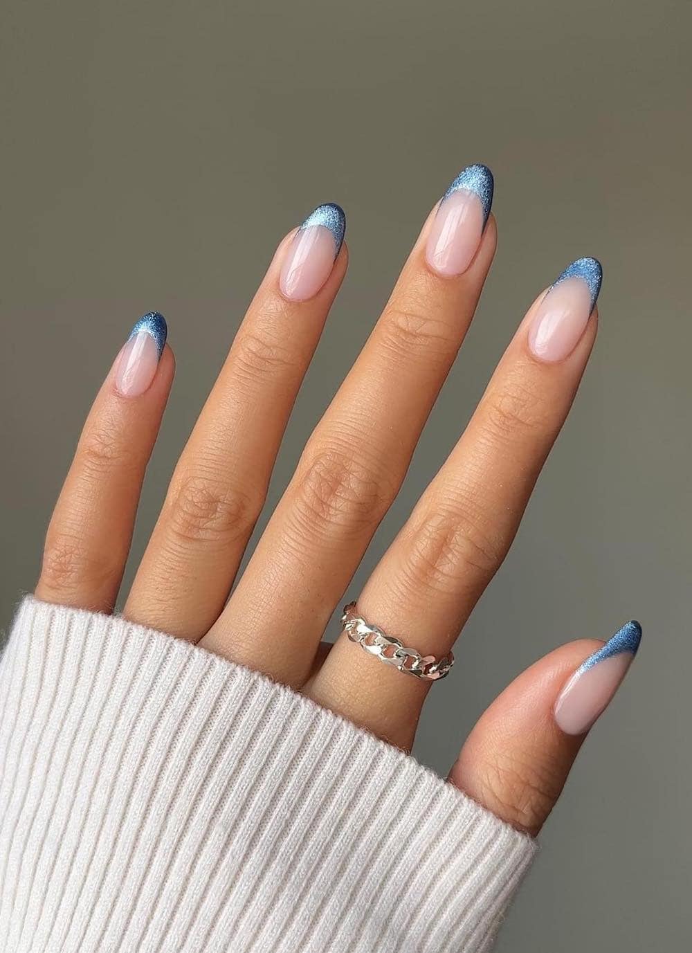 long milky nude nails with shimmering blue tips