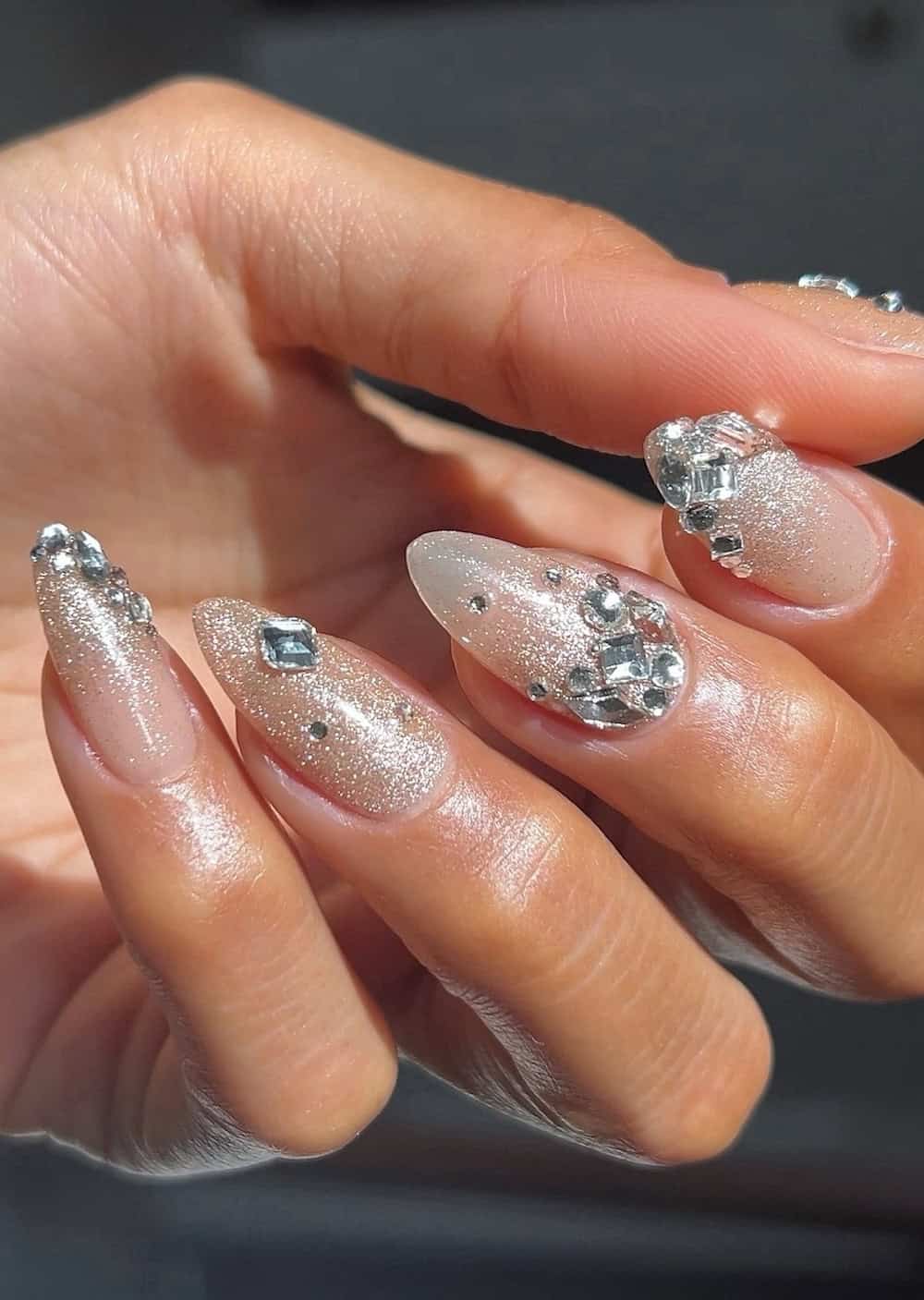 long shimmering almond nails with crystals