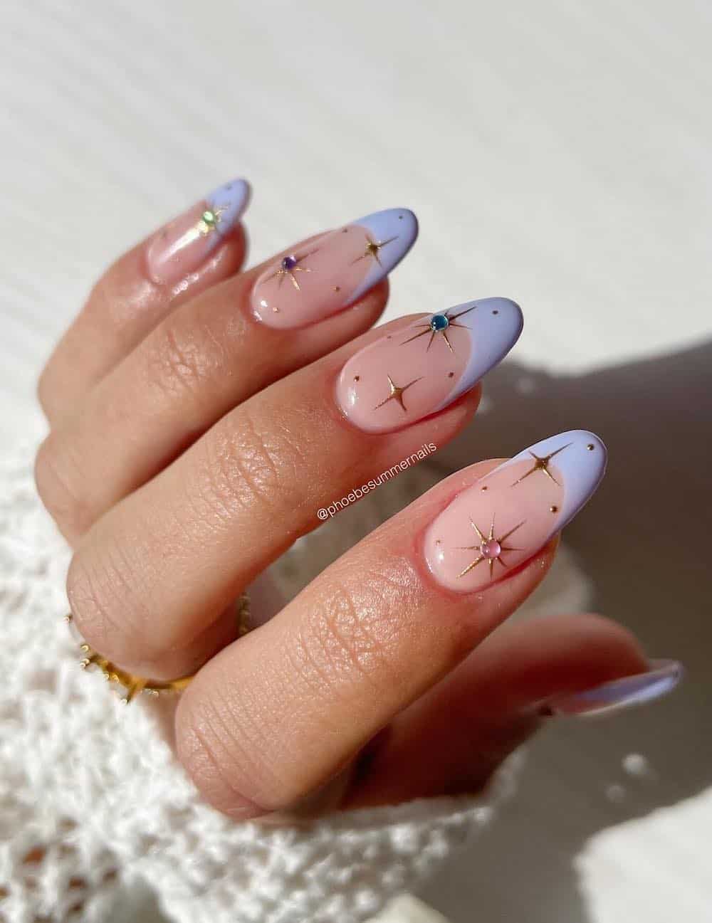 periwinkle french tips with gold sparkles and colorful gems